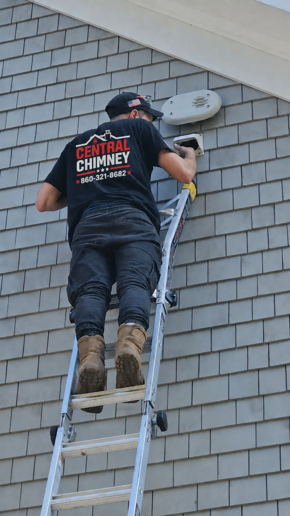 A man on a ladder wearing a black Central Chim